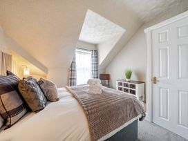 A bedroom with a bed and a window at The Keep in Llandudno