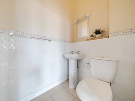 A bathroom with a sink and toilet at The Keep Llandudno