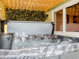 A hot tub with champagne and glasses at The Keep Llandudno