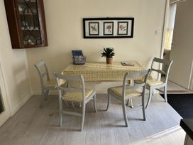 A dining room with a table and chairs at The White House in Torquay