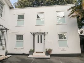 A house with windows and a door at The White House in Torquay