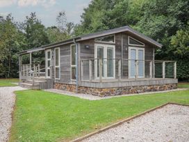An outdoor view of a cabin with a deck at 3 Southern Place in Dobwalls