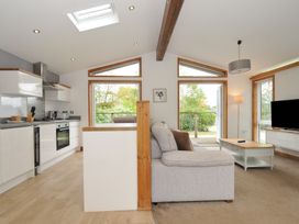 A living room and kitchen area with a sofa and kitchen units at 3 Southern Place in Dobwalls