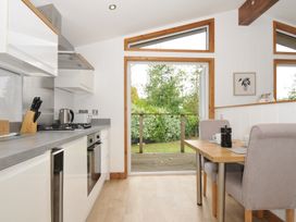 A kitchen with a dining table and chairs at 3 Southern Place in Dobwalls