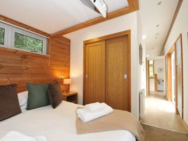 A bedroom with a bed and wooden wardrobe at 3 Southern Place in Dobwalls