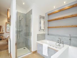 A bathroom with a shower and bathtub at 3 Southern Place in Dobwalls
