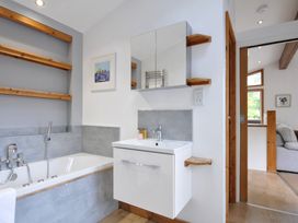 A bathroom with a bathtub and sink at 3 Southern Place Dobwalls