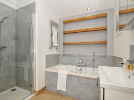 A bathroom with a shower and bathtub at 3 Southern Place Dobwalls