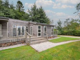 A cabin exterior with steps and a deck at 3 Southern Place in Dobwalls