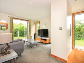 A living room with a television and sofa at 5 Faraway Fields in Dobwalls