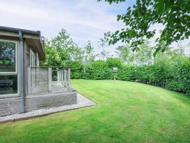 A garden with a balcony and grass at 5 Faraway Fields in Dobwalls