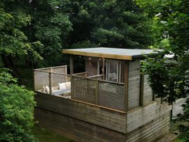 An outdoor area with seating and wooden railing at 24 Meadow Retreat in Dobwalls