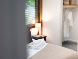A bedroom with a bed and lamp at 24 Meadow Retreat in Dobwalls
