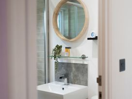 A bathroom with a sink and mirror at 24 Meadow Retreat in Dobwalls