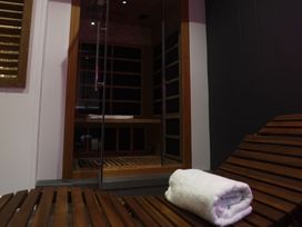 A sauna room with a wooden bench and a towel at 24 Meadow Retreat in Dobwalls