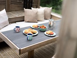 A table set with mugs, croissants, and fruits at 24 Meadow Retreat in Dobwalls