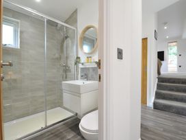 A bathroom with a shower, sink, and toilet at 24 Meadow Retreat in Dobwalls