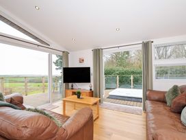 A living room with a television and sliding doors at 15 Faraway Fields in Dobwalls