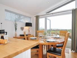 A dining room with a round table and chairs at 15 Faraway Fields in Dobwalls