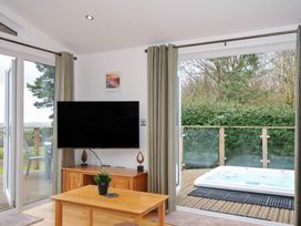 A living room with a television and a jacuzzi at 15 Faraway Fields in Dobwalls
