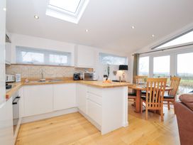 A kitchen with a dining table and chairs at 15 Faraway Fields in Dobwalls