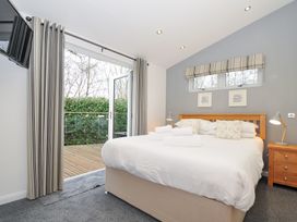 A bedroom with a bed and access to a terrace at 15 Faraway Fields in Dobwalls