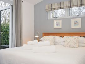 A bedroom with a bed and towels at 15 Faraway Fields in Dobwalls