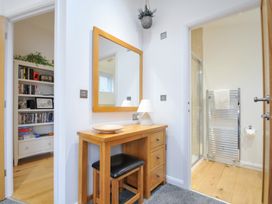A bathroom with a wooden table and mirror at 15 Faraway Fields in Dobwalls