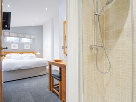A bedroom with a shower visible and a bed at 15 Faraway Fields Dobwalls