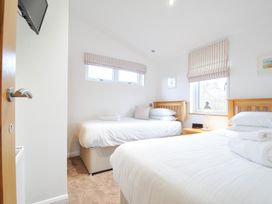 A bedroom with two beds and a bedside table at 15 Faraway Fields in Dobwalls