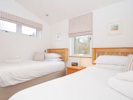 A bedroom with two beds and a nightstand at 15 Faraway Fields in Dobwalls