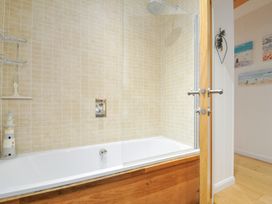 A bathroom with a bathtub and shower at 15 Faraway Fields Dobwalls