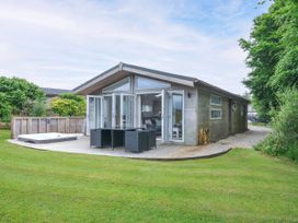 A house with a hot tub and decking in the garden at 1 Horizon View Dobwalls