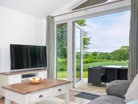 A living room with a television and a coffee table at 1 Horizon View in Dobwalls