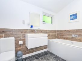 A bathroom with a toilet, sink, and bathtub at 1 Horizon View in Dobwalls