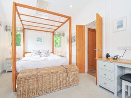 A bedroom with a canopy bed and storage basket at 1 Horizon View in Dobwalls