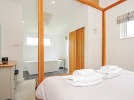A bedroom with a bed and towels on top at 1 Horizon View in Dobwalls
