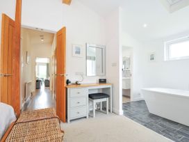 A bathroom with a bathtub and a desk at 1 Horizon View in Dobwalls