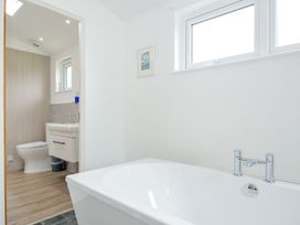 A bathroom featuring a bathtub and toilet at 1 Horizon View, Dobwalls
