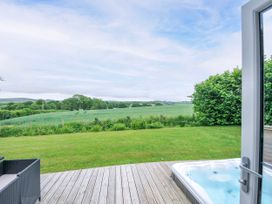 An outdoor space with a hot tub and seating area at 1 Horizon View in Dobwalls