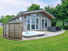 An outdoor area with a hot tub and seating at 1 Horizon View in Dobwalls