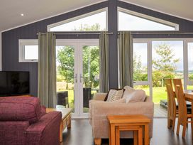 A living room with a sofa and dining table at 3 Horizon View, Dobwalls