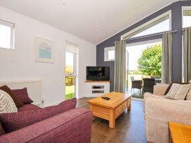 A living room with a sofa, coffee table and television at 3 Horizon View in Dobwalls