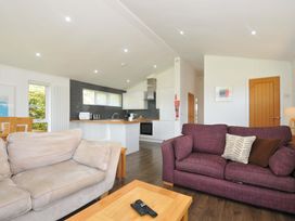 A living room with a sofa and kitchen area at 3 Horizon View in Dobwalls
