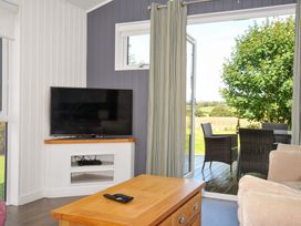 A living room with a television and a coffee table at 3 Horizon View in Dobwalls
