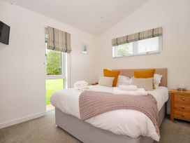 A bedroom with a double bed and a side table at 3 Horizon View, Dobwalls