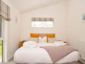 A bedroom with a double bed and side tables at 3 Horizon View in Dobwalls