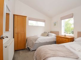 A bedroom with two beds and a wardrobe at 3 Horizon View Dobwalls