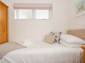 A bedroom with a bed and wooden wardrobe at 3 Horizon View in Dobwalls