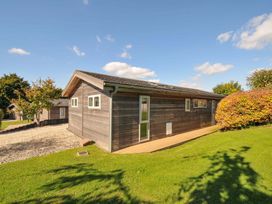 A wooden house with windows and door surrounded by grass at 3 Horizon View Dobwalls